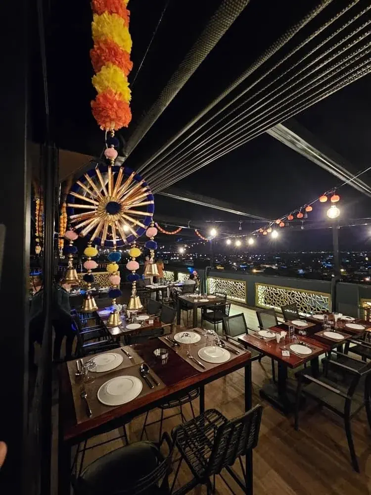 Skyline rooftop tables illuminated after sunset