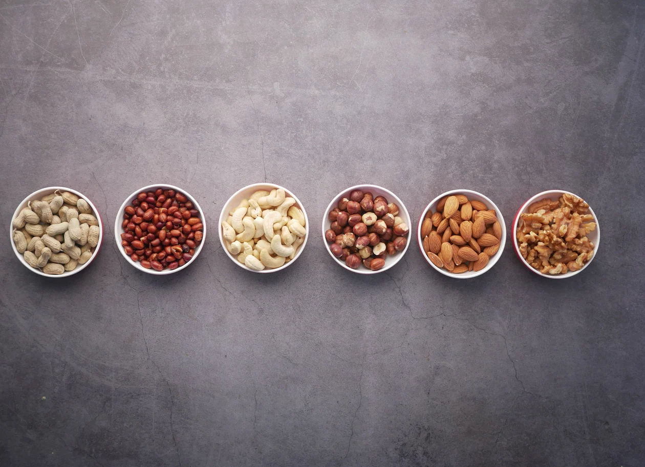 Cashews, almonds, walnuts and other nuts arranged in bowls