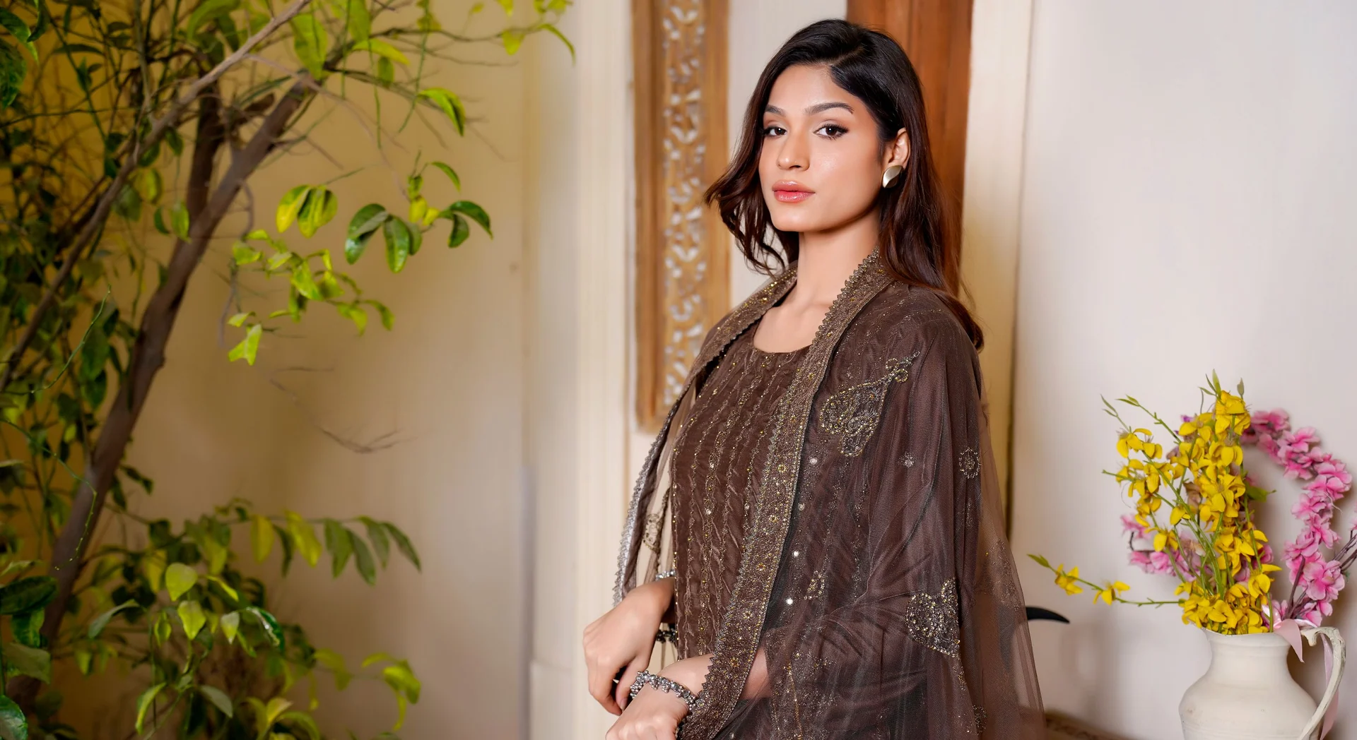 Woman wearing an embroidered ethnic outfit and dupatta